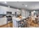 Modern kitchen featuring stainless steel appliances, white cabinetry, and a breakfast bar with seating at 744 Grand Market Ave, Berthoud, CO 80513