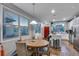 Open-concept dining area with bright kitchen featuring an island with barstool seating at 744 Grand Market Ave, Berthoud, CO 80513