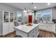 Bright kitchen featuring a center island with modern pendant lighting and stainless steel appliances at 744 Grand Market Ave, Berthoud, CO 80513