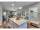 Open-concept kitchen and living area with white cabinetry, stainless steel appliances, and modern design at 744 Grand Market Ave, Berthoud, CO 80513