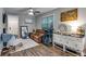 Inviting living room featuring wood floors, a ceiling fan, and natural light from large window at 744 Grand Market Ave, Berthoud, CO 80513