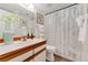 Bathroom featuring a stylish vanity, modern fixtures, and a shower-tub combo with decorative curtain at 6388 Oak Ct # 104, Arvada, CO 80004