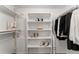A walk-in closet equipped with shelving, clothing racks, and storage space at 6388 Oak Ct # 104, Arvada, CO 80004