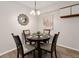 Cozy dining room featuring a modern light fixture, wood-look floors and seating for four at 6388 Oak Ct # 104, Arvada, CO 80004