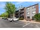 Exterior view of condo building shows balconies and parking with assigned space and easy access to the unit at 6388 Oak Ct # 104, Arvada, CO 80004