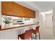 Kitchen featuring white cabinets, a pass through and breakfast bar with stool seating at 6388 Oak Ct # 104, Arvada, CO 80004