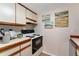Kitchen showcasing white cabinets and modern appliances at 6388 Oak Ct # 104, Arvada, CO 80004