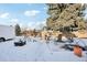 Snowy backyard with playset and shed at 10975 Birch Dr, Thornton, CO 80233