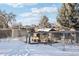 Snowy backyard with chicken coop and run at 10975 Birch Dr, Thornton, CO 80233