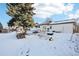 Snowy backyard with playset and shed at 10975 Birch Dr, Thornton, CO 80233