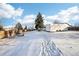 Snowy backyard with garden and storage shed at 10975 Birch Dr, Thornton, CO 80233