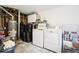 Unfinished basement laundry room with washer, dryer, and storage shelving at 10975 Birch Dr, Thornton, CO 80233