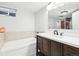 Basement bathroom with a soaking tub and modern vanity at 10975 Birch Dr, Thornton, CO 80233