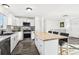 Modern kitchen with white cabinets, a large island, and stainless steel appliances at 10975 Birch Dr, Thornton, CO 80233