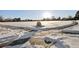 Snow covered pathways wind through a park with a stone marker at 10975 Birch Dr, Thornton, CO 80233