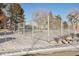 Outdoor tennis court with chain link fence in winter at 10975 Birch Dr, Thornton, CO 80233