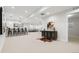 An open-concept basement has modern decor, lighting, and a bar with seating for 4 at 3041 S Bellaire S St, Denver, CO 80222
