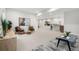 A modern basement has two chairs and a grey carpet with lighting highlighting the space at 3041 S Bellaire S St, Denver, CO 80222