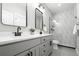 Bathroom featuring double vanity with gray cabinets, white countertops, and glass enclosed shower at 3041 S Bellaire S St, Denver, CO 80222