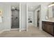 Bathroom featuring glass enclosed shower and single vanity with dark cabinets and gold hardware at 3041 S Bellaire S St, Denver, CO 80222