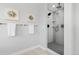 Bathroom featuring glass enclosed shower with black hardware, built-in shelves, and tiled flooring at 3041 S Bellaire S St, Denver, CO 80222