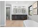 Bathroom showcasing dual vanities, soaking tub, and modern fixtures at 3041 S Bellaire S St, Denver, CO 80222