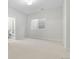 Clean bedroom with neutral walls and carpet, featuring a window and an ensuite bathroom at 3041 S Bellaire S St, Denver, CO 80222