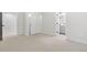 Bedroom with neutral carpet, ensuite bathroom, closet with sliding doors, and white trim at 3041 S Bellaire S St, Denver, CO 80222