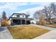 Charming two-story home features black brick accents, modern design, a well kept lawn, and an attached two car garage at 3041 S Bellaire S St, Denver, CO 80222