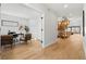 Open hallway featuring wood floors, a modern staircase, and a view into the home office at 3041 S Bellaire S St, Denver, CO 80222