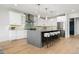 This contemporary kitchen features a large center island, stainless steel appliances, and white cabinetry with modern accents at 3041 S Bellaire S St, Denver, CO 80222