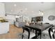 Open kitchen and dining area with modern appliances and a clear sightline into the living room at 3041 S Bellaire S St, Denver, CO 80222