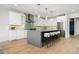 Modern kitchen with stainless steel appliances, white cabinetry, and tiled backsplash at 3041 S Bellaire S St, Denver, CO 80222