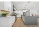 This modern kitchen features white cabinets, stainless steel appliances, a center island, and tile backsplash at 3041 S Bellaire S St, Denver, CO 80222