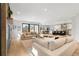 Spacious living room with modern design, connected to kitchen, and filled with natural light at 3041 S Bellaire S St, Denver, CO 80222