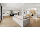 Bright, open living room flowing into kitchen with hardwood floors and ample seating at 3041 S Bellaire S St, Denver, CO 80222