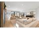 Spacious open-concept living room with hardwood floors, stone fireplace and ample natural light, perfect for gatherings at 3041 S Bellaire S St, Denver, CO 80222