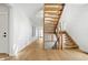 Bright hallway featuring an open wooden staircase with modern railings and ample natural light at 3041 S Bellaire S St, Denver, CO 80222