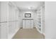 Walk-in closet featuring white shelving and cabinets, providing ample storage space at 3041 S Bellaire S St, Denver, CO 80222