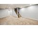 Large finished basement with carpeted floors and staircase to the upper levels at 3932 Tejon St, Denver, CO 80211