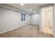 Clean basement space with carpeted floors, a window, and an open doorway to another room at 3932 Tejon St, Denver, CO 80211