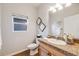 Bright bathroom with a granite vanity, decorative accents, and tile flooring offering a clean, modern look at 3932 Tejon St, Denver, CO 80211