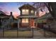 Charming two-story home with a front porch and black iron fence, perfect for enjoying neighborhood views at 3932 Tejon St, Denver, CO 80211