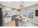 Modern kitchen featuring stainless steel appliances, granite countertops, a kitchen island, and ample natural light at 3932 Tejon St, Denver, CO 80211