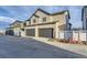 Modern two-story home featuring a two-car garage and neutral-toned siding under a partly cloudy sky at 1286 S Algonquian St, Aurora, CO 80018
