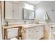 Clean and modern bathroom with vanity, mirror, and neutral decor at 1372 Gaylord St # 4, Denver, CO 80206