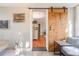 Bright dining area with a sliding barn door and view into other areas of the house at 1372 Gaylord St # 4, Denver, CO 80206
