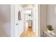 Inviting hallway with hardwood floors, neutral paint, and bright doorways leading to other rooms at 1372 Gaylord St # 4, Denver, CO 80206