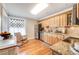 Charming kitchen featuring wooden cabinets, granite countertops, and stainless steel appliances at 1372 Gaylord St # 4, Denver, CO 80206