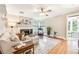 Bright living room featuring a fireplace, large windows, and comfortable seating, perfect for relaxation at 1372 Gaylord St # 4, Denver, CO 80206